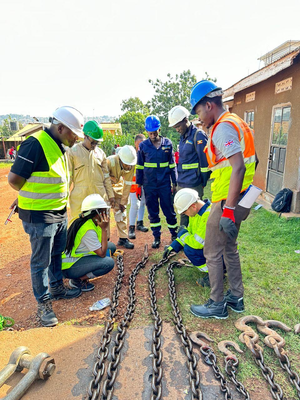 Engineering team inspecting heavy lifting rigging chains and master link slings