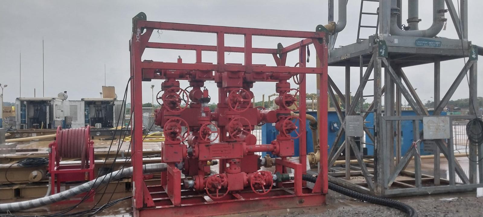 Heavy mobile crane hoisting drilling rig substructure during rig move